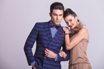 Handsome young fashion man holding his lovers arm