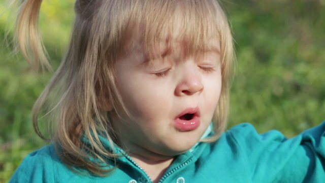 Little girl sneezes
