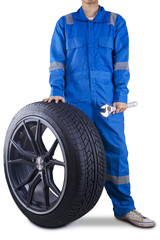 Naklejka premium Mechanic holding a tire and wrench