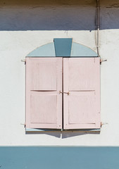 Pink Shutters on Stucco Wall