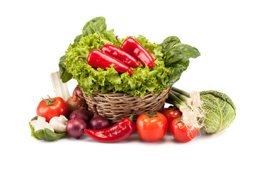 Full basket of ripe vegetables on white background