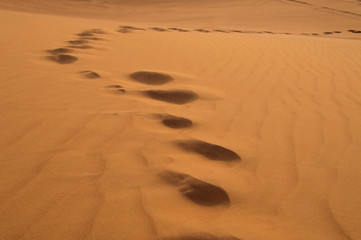 footprints on sand dune in Rub 'al Khali, United Arab Emirates