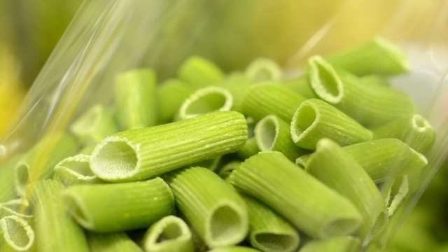 chef puts dried pasta into bags - closeup (detail)