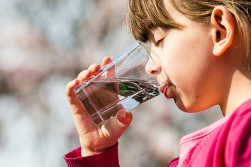 Girl drinking water from glass