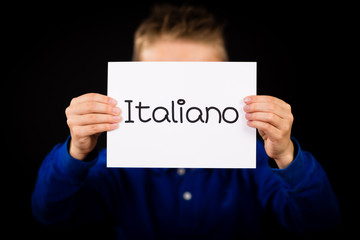 Child holding sign with Italian word Italiano - Italian in Engli