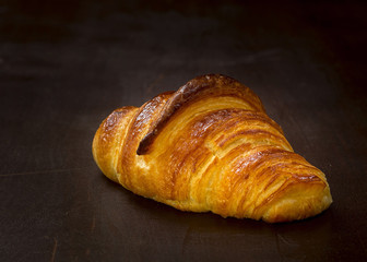 french croissant on a wooden table