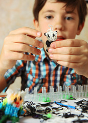 preteen hansome boy show  the result of his rainbow loom hobby p
