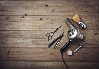 Vintage barber equipment on wood background with place for text
