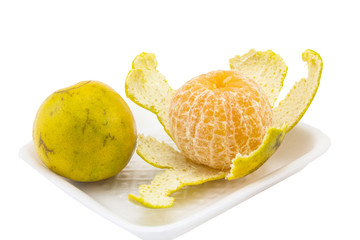 peel orange and normal orange on white foam tray isolated white