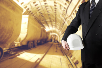 Close up of engineer hand holding white safety helmet for worker