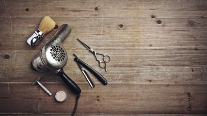Vintage barber equipment on wood desk with place for text