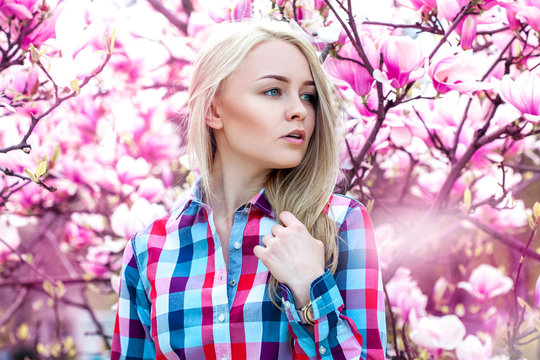 Perfect serious cute blonde looking away with fowers