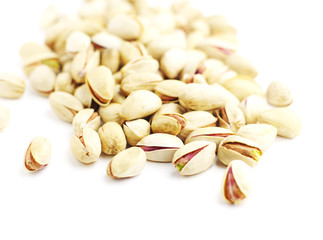 Pistachio nuts in shell, shallow DOF.