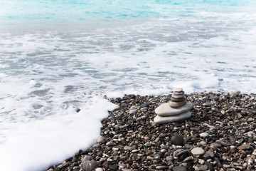 Fototapeta na wymiar The pyramid of pebbles on the beach