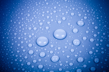 Drops of water on a color background. Blue. Shallow depth of fie