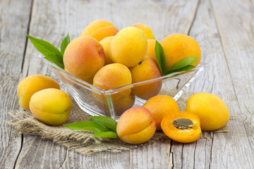 Naklejka na ściany i meble fresh apricots in a bowl on wooden background