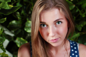 Closeup of beautiful girl with long blond hair and green eyes