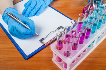 laboratorian describes the result with test tubes