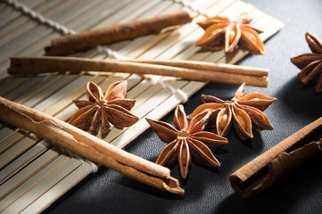 anise-star and cinnamon stick on bamboo mat.