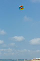 parachute in the sky over the sea
