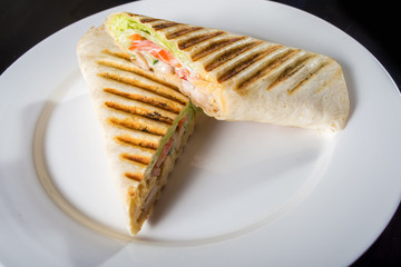 Two sandwiches with vegetables and meat