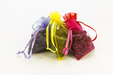 Coffee beans in gift bags on the white background
