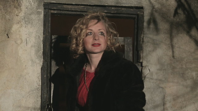 Frightened woman in tears trying to open locked door at night