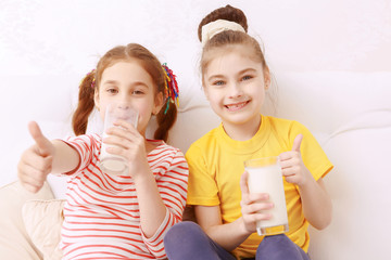 Two cute kids judging milk