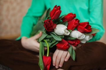 close up of children's hands with a bouquet of flowers