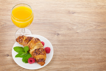Orange juice and fresh croissant