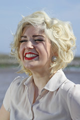 Obraz na płótnie Canvas Stunning blonde haired teenage girl at the beach
