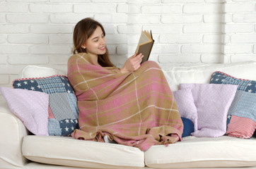Relaxing woman lying comfortable in sofa.