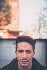 Young  man posing in an urban context
