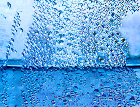 Blue water drops taken closeup as abstract background.