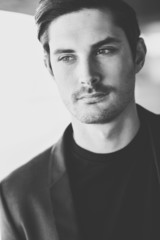 Attractive young businessman in urban background