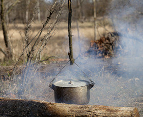 Cooking in sooty cauldron on campfire