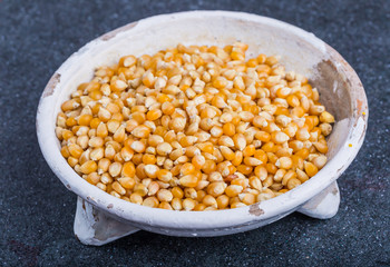 Dry grain corn in a white bowl