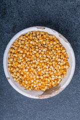 Dry grain corn in a white bowl
