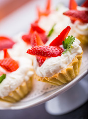 Delicious cupcake with whipped cream and fresh strawberries