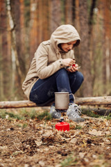 girl prepares food on a gas burner