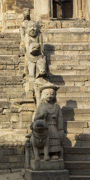 Statues on the steps of an ancient temple in Bhaktapur, Nepal