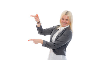 young blond woman is smiling and pointing sideward