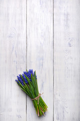 spring flowers bouquet on wooden table. Top view, copy space.