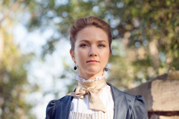 Portrait of romantic young beautiful lady outdoors