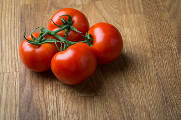 Fresh and tasty tomatoes on a wooden table