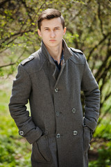 young man in a gray coat