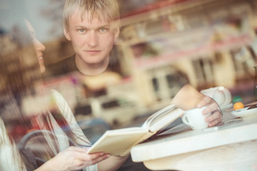Happy young couple in cafe, having a great time together.