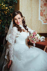 Fototapeta premium Gorgeous bride blonde in wedding dress on luxury interior with
