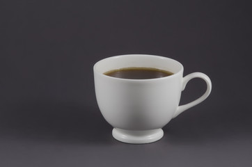 White coffee cup with black coffee isolated on grey