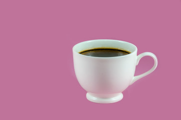White coffee cup with black coffee isolated on pink